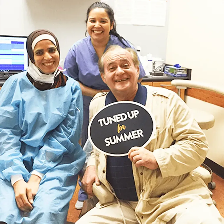 Dr. Afrin Mariyam and a team member with a happy patient
